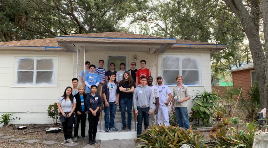 Photo of Nathan Hamilton and his Key Club crew painting a house.